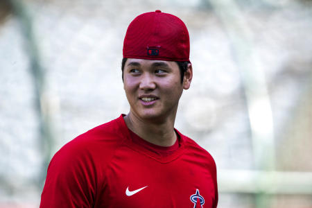 Los Angeles Angels' Shohei Ohtani walks on the field after warming up for the team's baseball game against the Los Angeles Dodgers in Anaheim, Calif., Saturday, July 16, 2022. (AP)