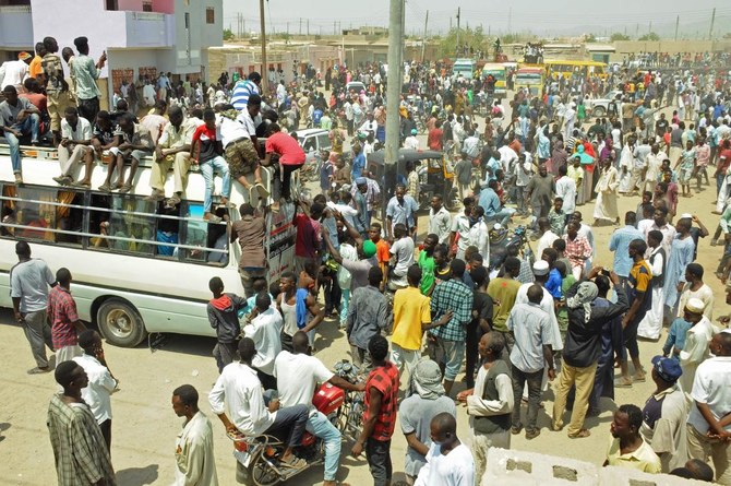 Scores of Hausa people gather outside local government offices in Port Sudan, on the Red Sea, on Tuesday to demand justice for comrades killed in a deadly land dispute with a rival ethnic group in the country’s south. (AFP)