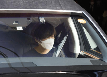 Akie Abe, wife of Japan's former Prime Minister Shinzo Abe, is seen in the hearse carrying Abe's body as they leave their residence for Zojoji temple for the funeral wake in Tokyo, Japan, Monday, July 11, 2022. (AP)