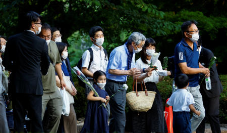 People lay flowers at Zojoji Temple, where the vigil and funeral of late former Japanese Prime Minister Shinzo Abe will be held, in Tokyo, Japan July 11, 2022. (Reuters)