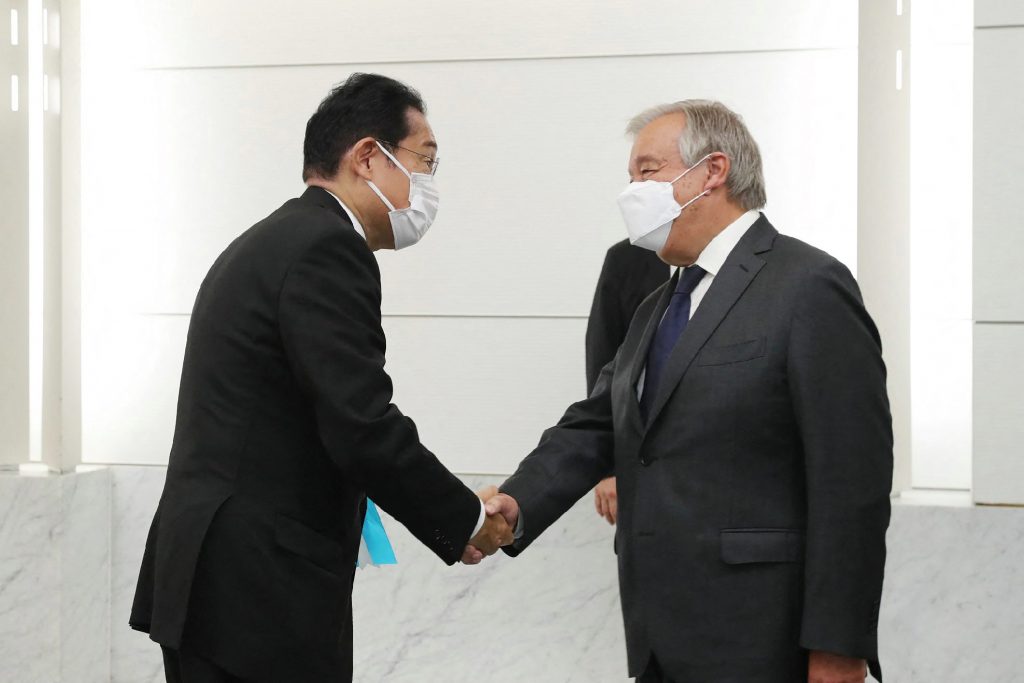 Japan's Prime Minister Fumio Kishida (L) shakes hands with UN Secretary General António Guterres. (AFP)