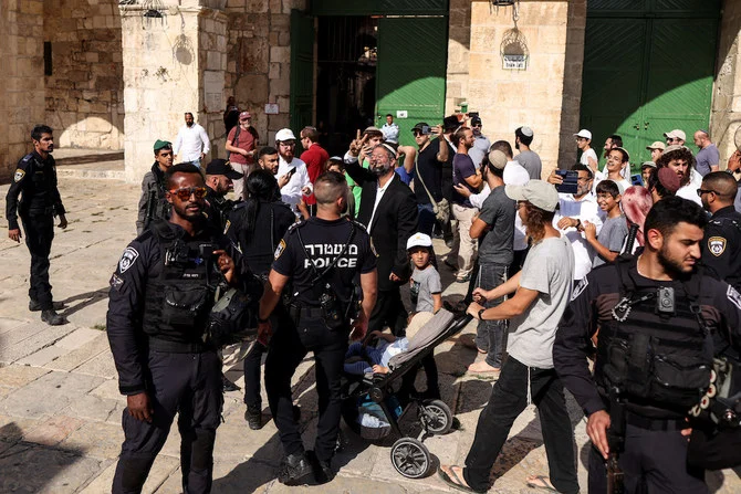 Israeli police stand by as Jews, including Israeli far-right lawmaker Itamar Ben Gvir, visit the compound known to Muslims as Noble Sanctuary and to Jews as Temple Mount in Jerusalem's Old City as Israel marks Tisha B'Av, on August 7, 2022. (Reuters)