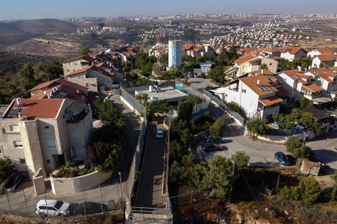 An aerial view of the Palestinian Gharib family’s house as an enclave in between Israeli army barriers, at the Jewish settlement of Givon Hahadasha north of Jerusalem, bordering the Palestinian village of Beit Ijza, in July. (AFP)