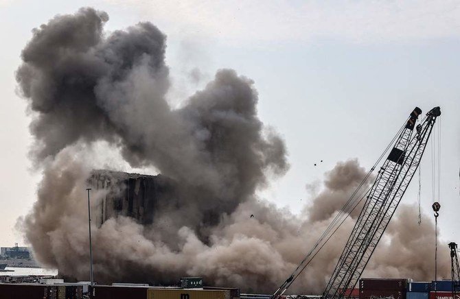 Dust rises from collapsing silos damaged during the August 2020 massive explosion in the port, in Beirut, Lebanon, Thursday, Aug. 4, 2022. (AFP)