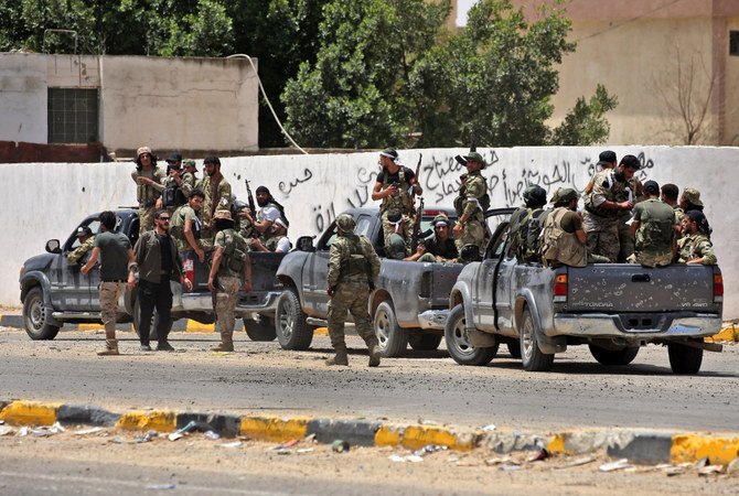 In this June 4, 2020 photo, fighters loyal to the UN-recognized Libyan Government of National Accord (GNA) deploy along a road in Tripoli. (AFP)