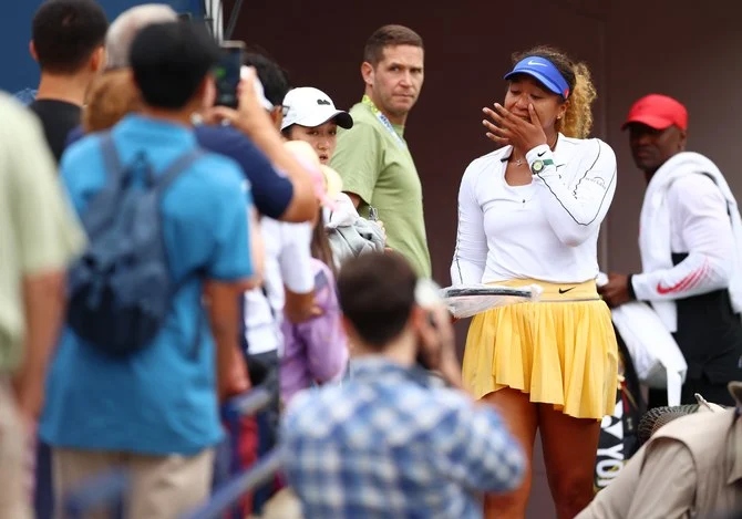 Naomi Osaka of Japan wipes a tear after she retired early from her match against Kaia Kanepi of Estonia during the National Bank Open at Sobeys Stadium on Aug. 9, 2022 in Toronto. (AFP)