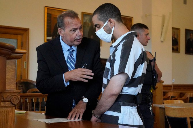 Nathaniel Barone, left, defense attorney for Hadi Matar, talks with his client following an arraignment at a courthouse in Mayville, New York, on Aug. 13, 2022. (AP Photo/Gene J. Puskar)