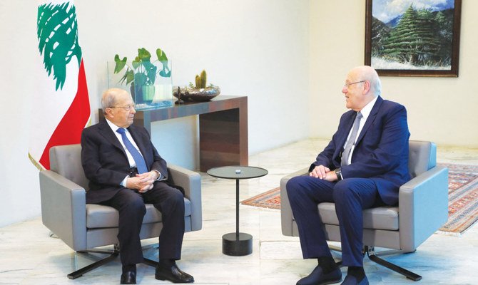 Lebanon’s Prime Minister Najib Mikati confers with President Michel Aoun during a meeting at the presidential palace in Baabda, east of Beirut. (AFP)