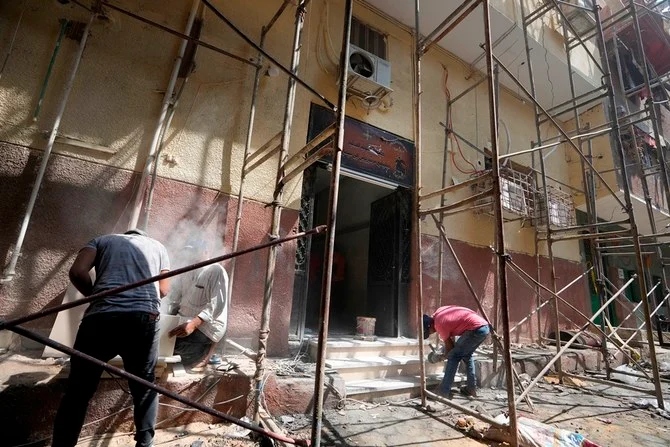 Workers restore the entrance of the Abu Sefein church in Egypt. (AP)