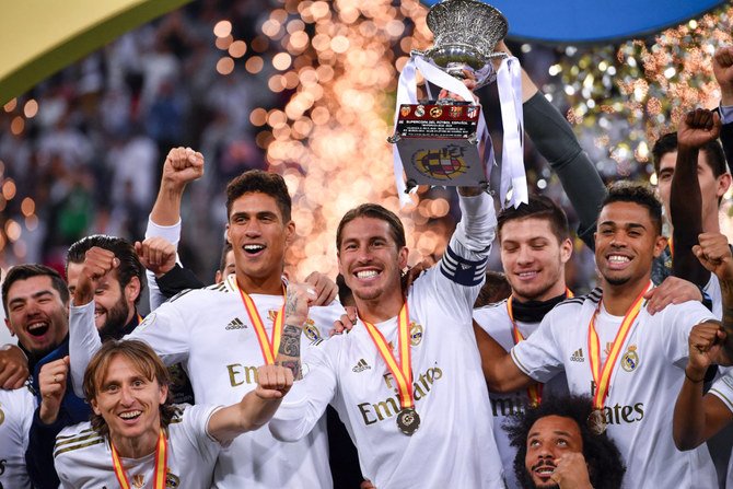 Real Madrid players celebrate beating Atletico Madrid for the Spanish Super Cup title on Jan. 12, 2020, at the King Abdullah Sports City in Jeddah. (AFP)