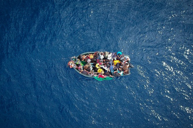 A boat carrying migrants stranded in the Strait of Gibraltar before being rescued by the Spanish Guardia Civil and the Salvamento Maritimo sea search and rescue agency. (AFP)