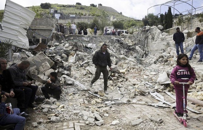 Palestinians at the site of a family home destroyed by Israeli authorities in East Jerusalem’s neighborhood of Silwan, April 17, 2019. (AP Photo)
