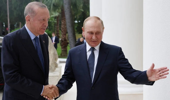 Russia's President Vladimir Putin (R) shaking hands with Turkish President Recep Tayyip Erdogan on August 5, 2022. (AFP/File)