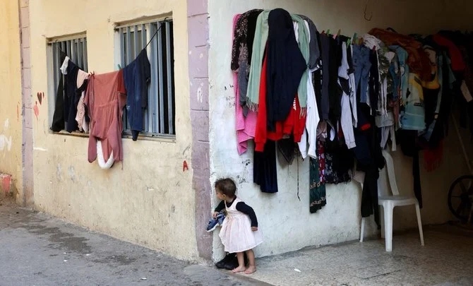 A child peeks from behind the corner of a building in Beirut’s Karantina district, Lebanon, Nov. 22, 2021. (Reuters)