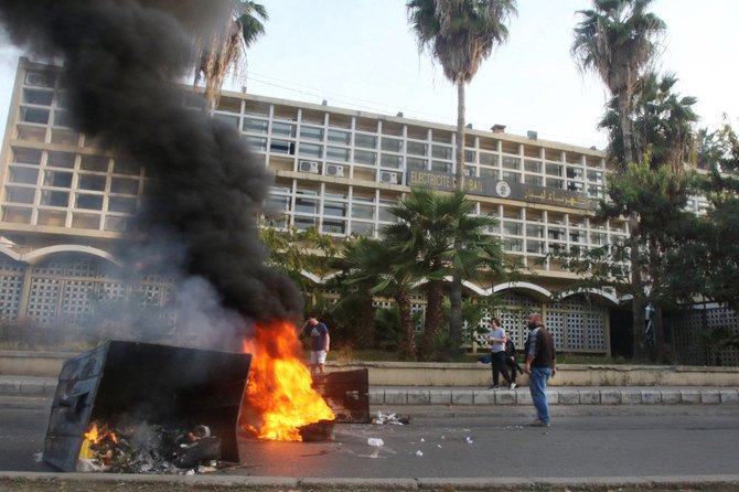 Lebanese demonstrators block a road with burning tyres in front of the Electricite Du Liban company building in the southern city of Sidon, as the country struggles with a deep economic crisis. (AFP file photo)