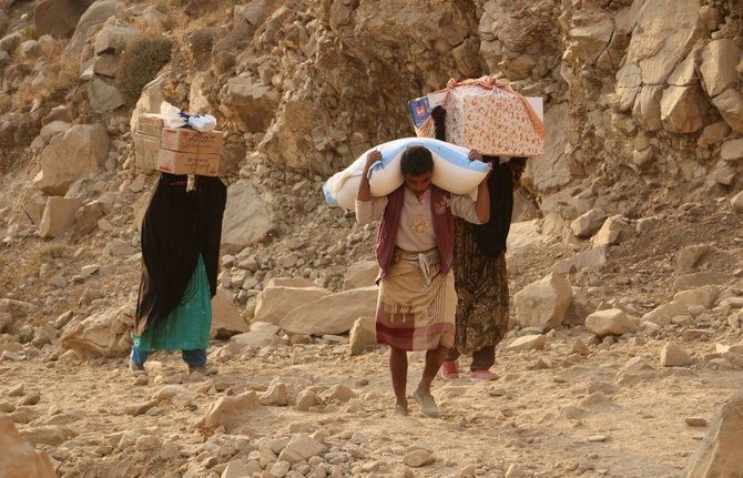 Yemenis carry relief supplies, along a mountain path, to the besieged city of Taiz. (AP Photo)