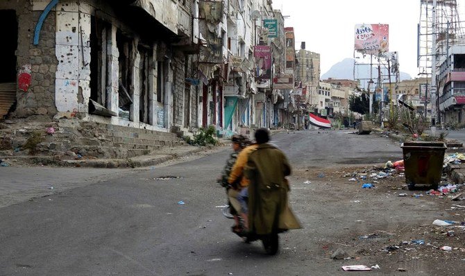 Yemenis maneuver through rubble strewn streets in the besieged city of Taiz. (AP Photo)