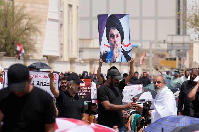 Supporters of Shiite cleric Muqtada Al-Sadr with his poster gather near the parliament building in Baghdad, Aug. 26, 2022. (AP)