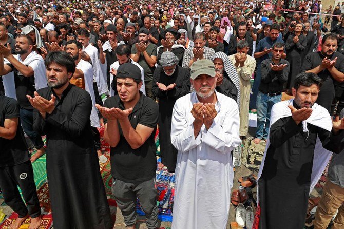 Supporters of Iraqi Shiite cleric Moqtada Sadr gather for the weekly Muslim Friday prayers during their vigil outside parliament headquarters in Baghdad's Green Zone on Friday. (AFP)