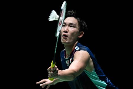 In this file photo taken on July 2, 2022, Japan's Kento Momota hits a return against Thailand’s Kunlavut Vitidsarn during their men’s singles semi-final match at the Malaysia Open badminton tournament in Kuala Lumpur. (AFP)
