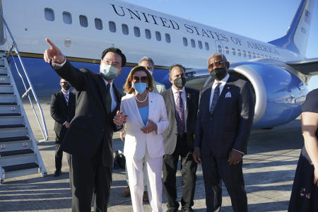 In this photo released by Taiwan's Ministry of Foreign Affairs, Taiwan's Foreign Minister Joseph Wu (left), gestures while speaking with US House Speaker Nancy Pelosi as she prepares to leave Taipei, Taiwan, Wednesday, Aug. 3, 2022. (Taiwan Ministry of Foreign Affairs via AP)