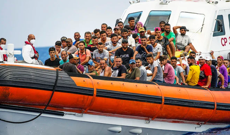 Migrants rest on board an Italian coast guard ship after being rescued southwest of the Italian island of Lampedusa in the Mediterranean Sea. (AP/File)