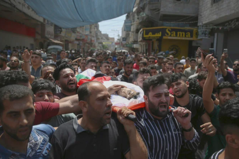 Mourners carry one body of six Palestinians including children killed in an explosion in Jebaliya refugee camp, northern Gaza Strip, Aug. 6, 2022. (AP)