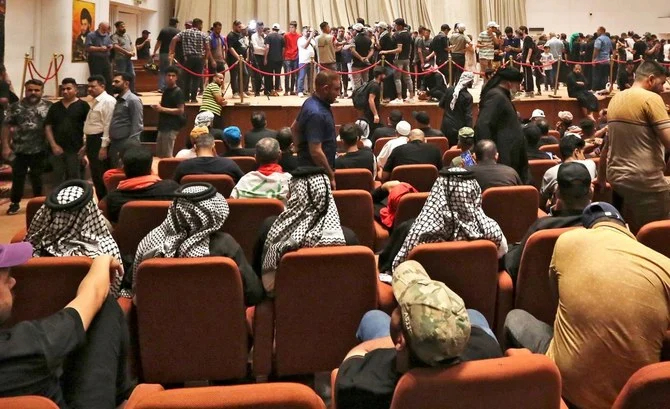 Supporters of the Iraqi cleric Moqtada Sadr gather inside the great conference hall at the parliament in Baghdad’s high-security Green Zone on Tuesday. (AFP)