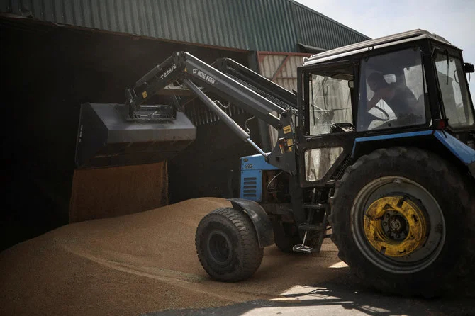 A farmer on a tractor moves grain at the storage facility of Vitalii Kistrytsya, as Russia's attack on Ukraine continues, in Dnipropetrovsk region. (Reuters)