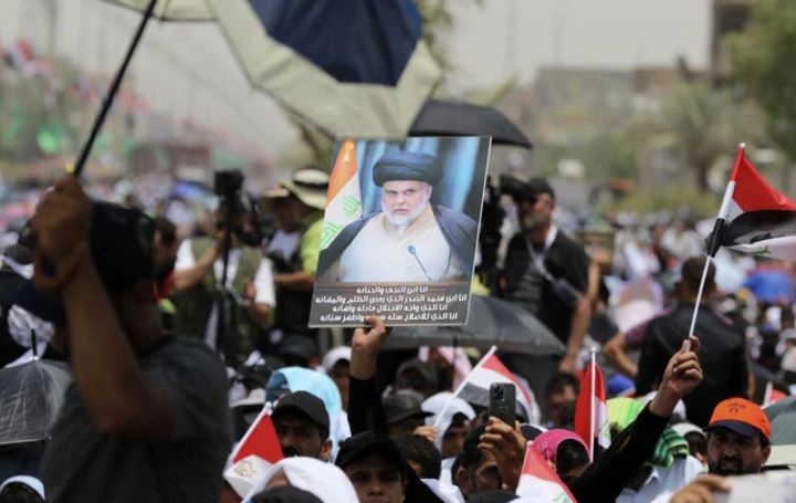 Residents of the impoverished Baghdad suburb of Sadr City pledge support to Al-Sadr, an influential cleric who called on thousands of his followers to storm Iraq's parliament. (AP)