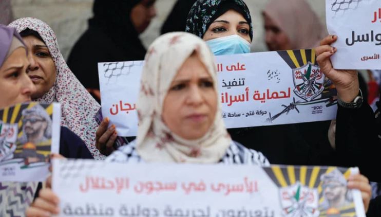 Protesters take part in a demonstration outside the ICRC headquarters in Gaza City in support of hunger-striking Palestinian prisoners in Israeli jails. (AFP)