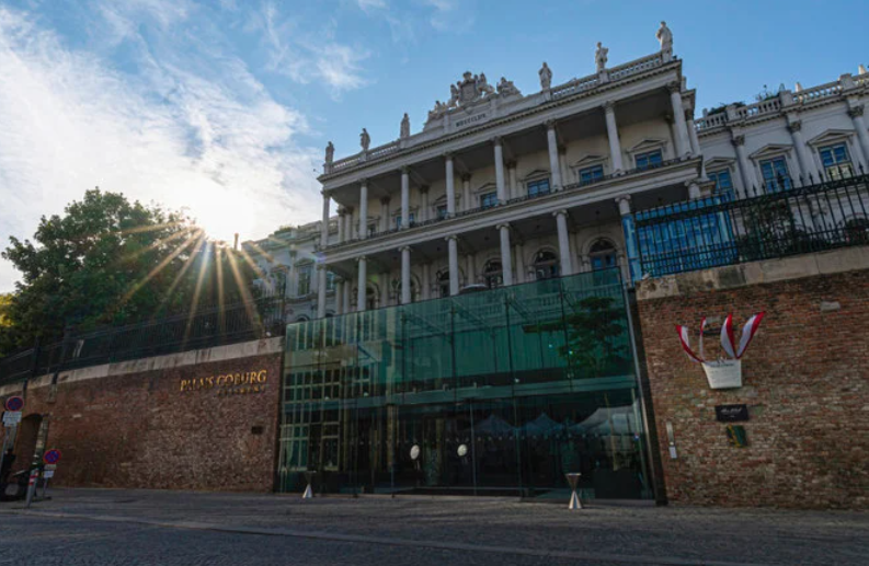 The sun sets behind the Palais Coburg where closed-door nuclear talks take place in Vienna, Austria, on Aug. 5, 2022. (AP)