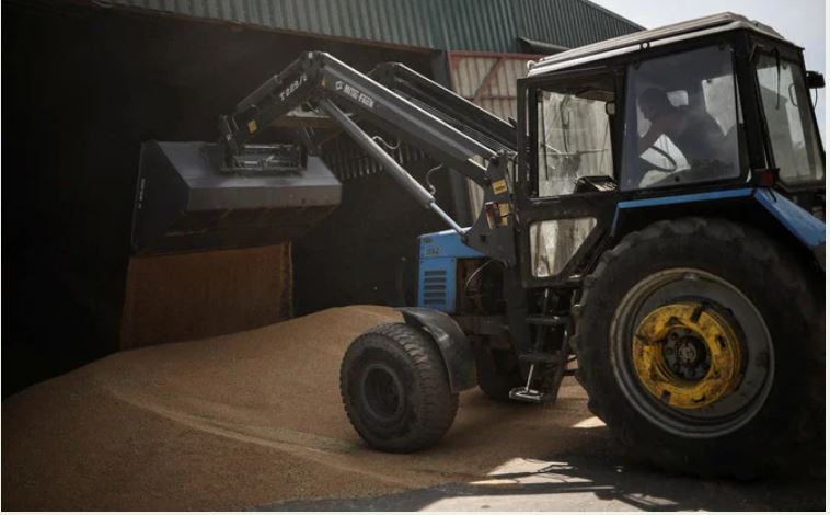 Farmer on a tractor moves grain at the storage facility of Vitalii Kistrytsya, as Russia's attack on Ukraine continues, in Dnipropetrovsk region. (Reuters)