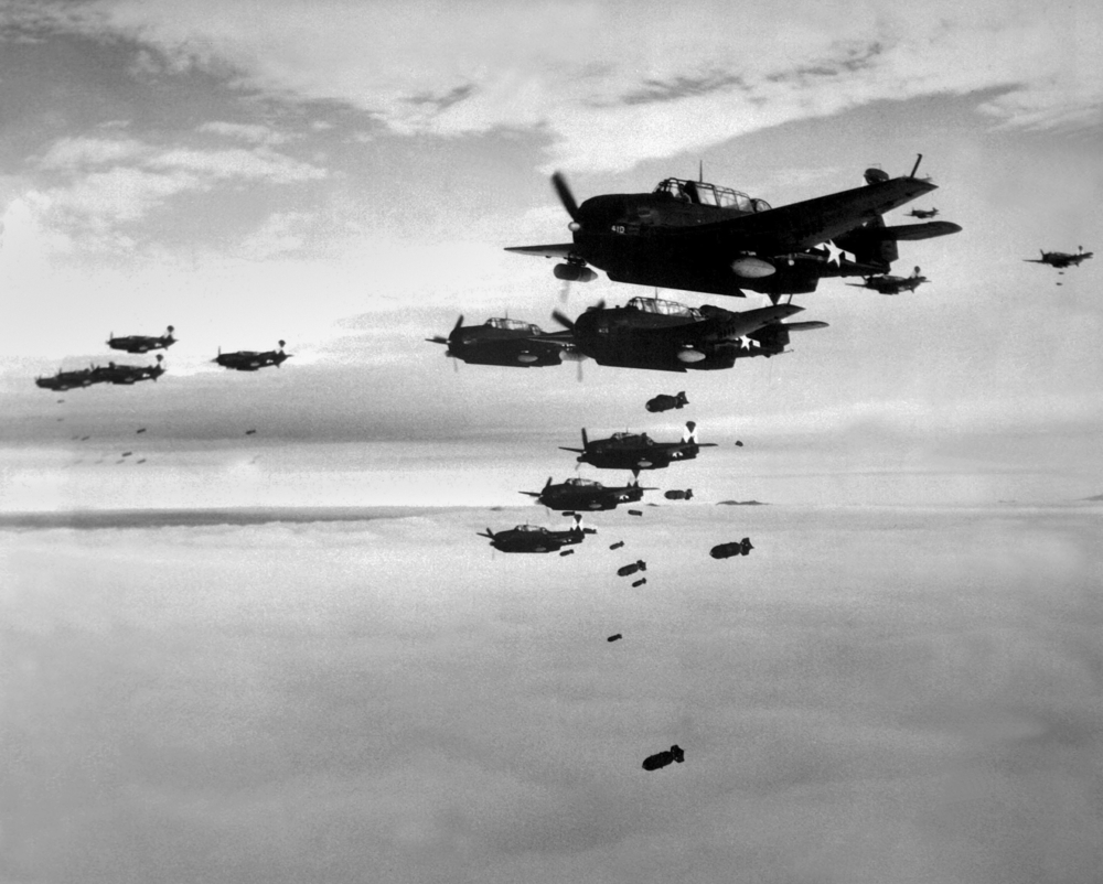Planes from the USS Essex aircraft carrier dropping bombs on Hokadate, Japan, July 1945. World War 2, Pacific Ocean. (Shutterstock)