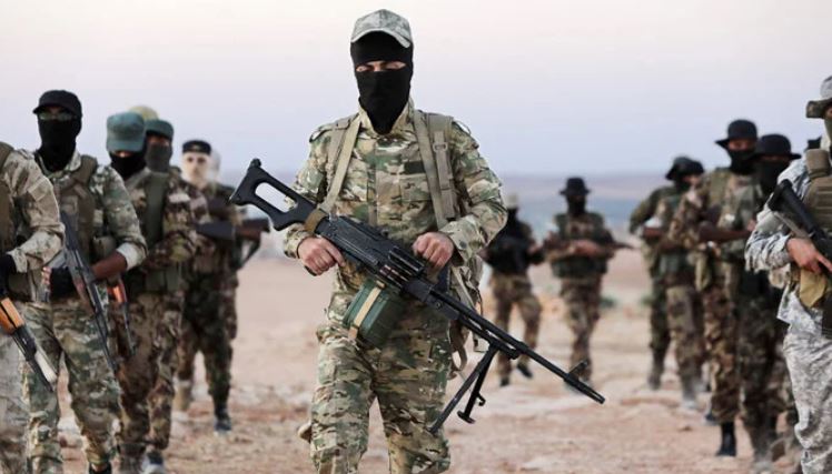 Turkey-backed Syrian fighters man a position outside the town of Kuljibrin, in the country’s northern Aleppo governorate. (AFP)