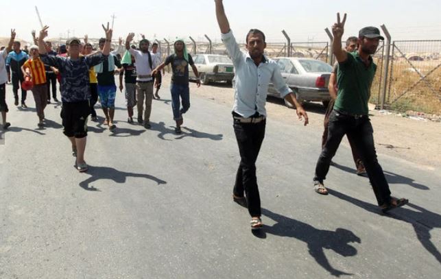 Displaced Iraqi Yazidis, who fled a jihadist onslaught on Sinjar, demonstrate demanding more aid at the Bajid Kandala camp in Kurdistan's western Dohuk province. (AFP)