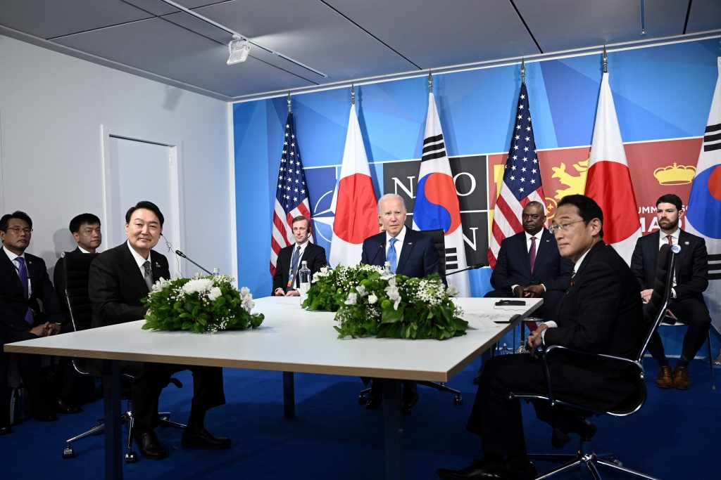 US President Joe Biden (C) sits with South Korea's President Yoon Suk-Yeol (L) and Japan's Prime Minister Fumio Kishida during a trilateral meeting on the sidelines of the NATO summit at the Ifema congress centre in Madrid, June. 29, 2022. (AFP)