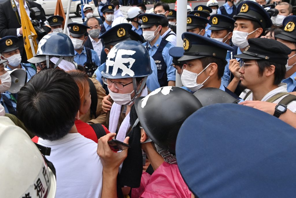 People protest against the state funeral. (AFP)