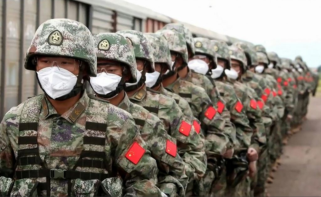 This screen grab obtained from a handout video released by the Russian Defence Ministry on August 29, 2022, shows Chinese soldiers marching along a railway platform upon their arrival for 'Vostok-2022' military exercises at the Sergeevsky training ground at Primorskiy (Maritime) Kray of the Russian Far East. (AFP)