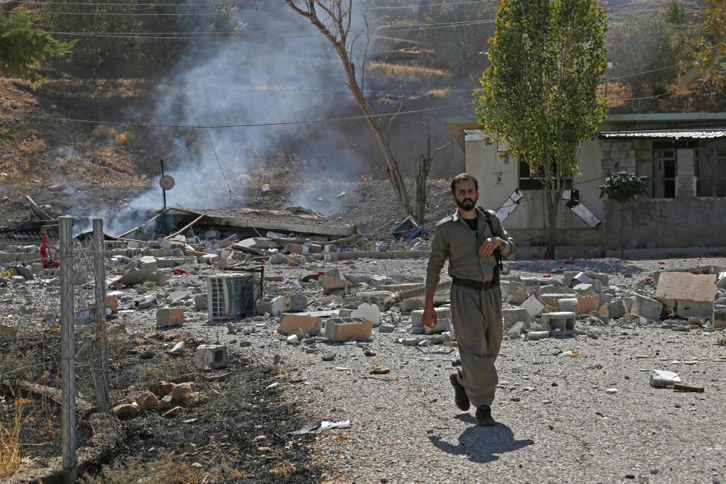 A Kurdish peshmerga fighter inspects the damage following an Iranian cross-border attack in the area of Zargwez, where several exiled left-wing Iranian Kurdish parties maintain offices, around 15 kilometres from the Iraqi city of Sulaimaniyah on Sep. 28, 2022