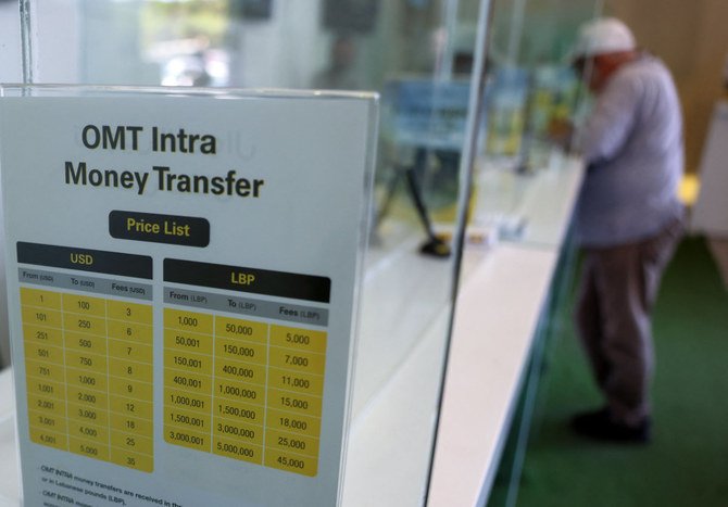 A man awaits his cash at a money transfer office in Lebanon's capital Beirut, on July 27, 2022. (AFP)