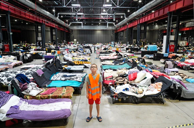 Sasha, a 12-year-old refugee from Ukraine, poses for a photo hat the Humanitarian Aid Center set up at the Global Expo exhibition hall in Warsaw on July 15, 2022. (AFP)