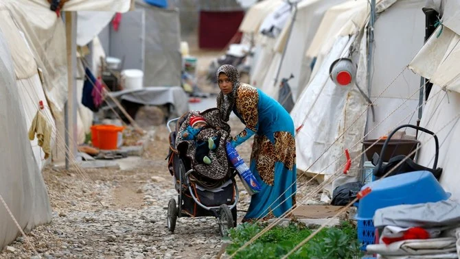 A Syrian refugee mother puts her baby in a stroller, Nizip refugee camp, Gaziantep province, Turkey, Nov. 30, 2016. (Reuters)