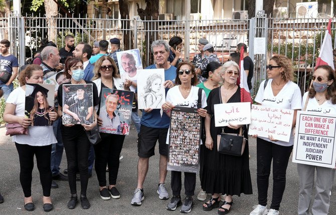 Relatives of some of the victims of the August 2020 Beirut port blast carry their pictures and banners during a protest outside the Justice Palace, in Beirut, Lebanon September 7, 2022. (Reuters)