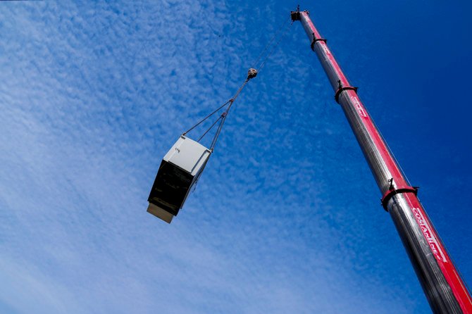 A new generator is lifted to a roof to replace an old generator in Beirut, Lebanon, Feb. 21, 2022. (AP)
