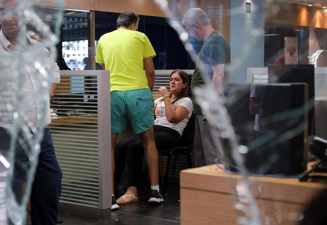 A woman is comforted at a Blom Bank branch after a group of depositors took hostages in Beirut, Lebanon on Sept. 14, 2022. (Reuters)