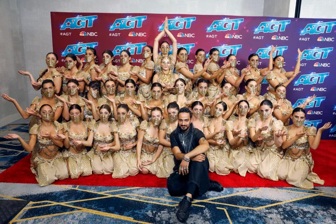 Terry Crews, center, poses with members of the female Lebanese dance troupe Mayyas after winning 