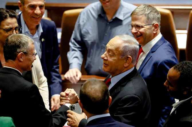 Former Israeli Prime Minister Benjamin Netanyahu is surrounded by Likud party members at the Israeli parliament, the Knesset in Jerusalem, June 22, 2022. (REUTERS)