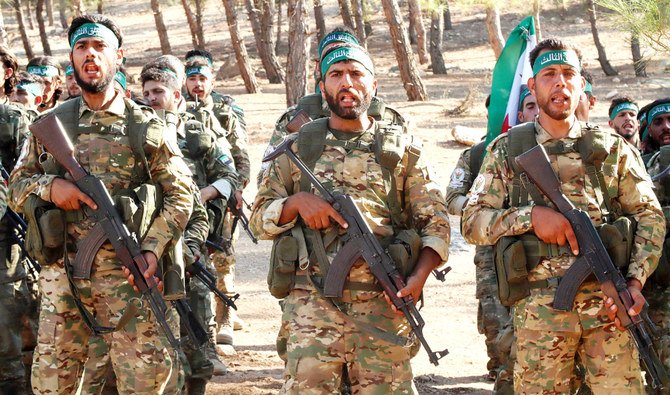 Fighters from the Free Syrian Army take part in a military training exercise near the border town of Azaz in the north of the Aleppo province. (AFP)