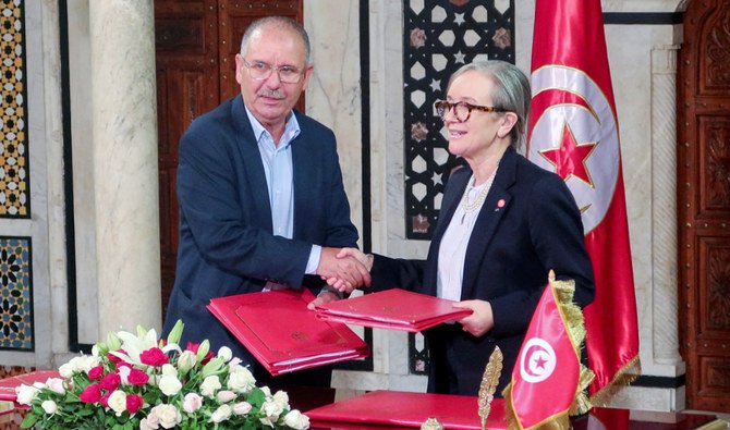 Tunisian General Labour Union Secretary-General Noureddine Taboubi greets Tunisian Prime Minister Najla Bouden during the signing of wages deal in Tunis. (REUTERS)